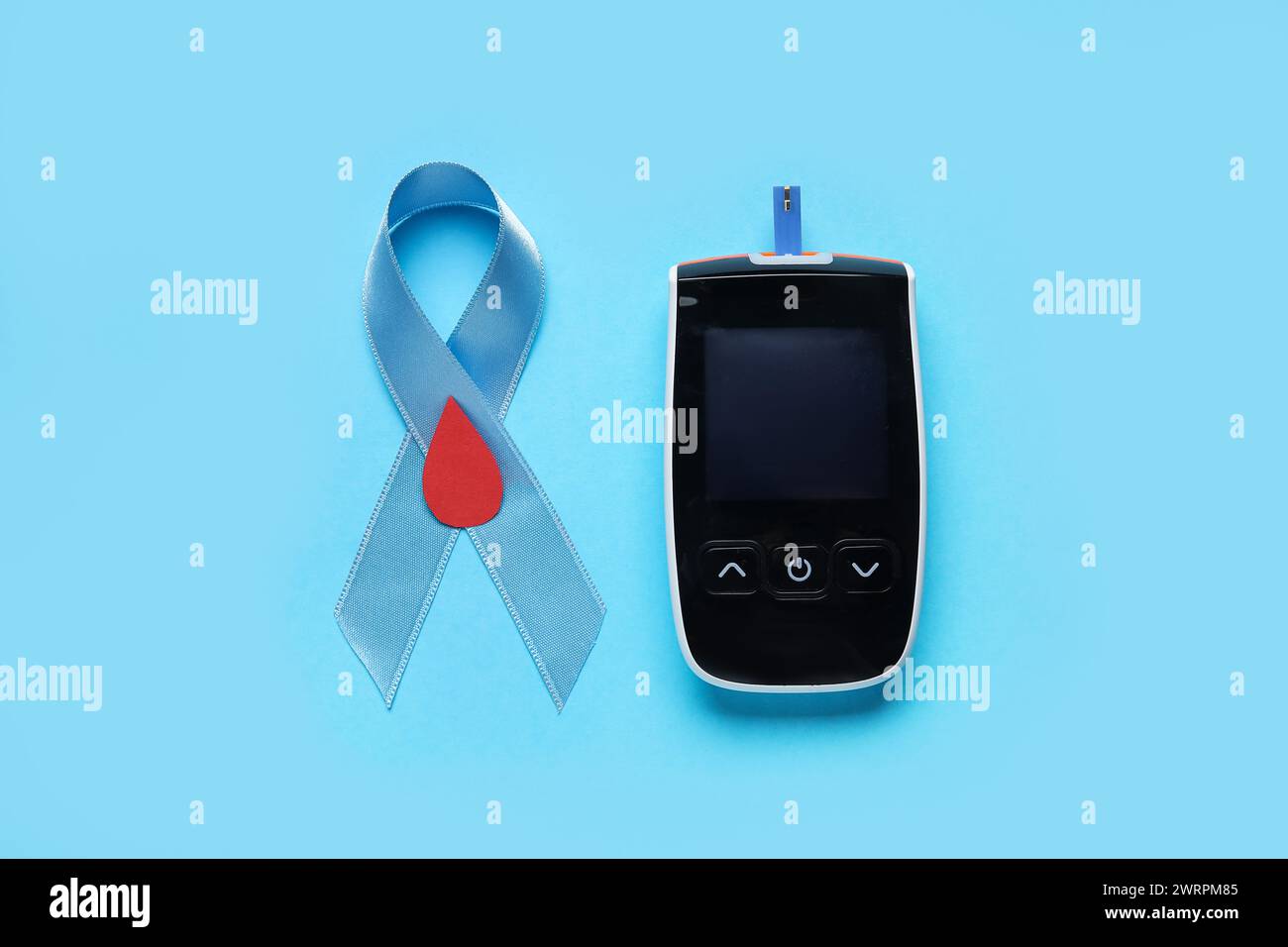 Awareness ribbon with glucometer on blue background. Diabetes concept ...