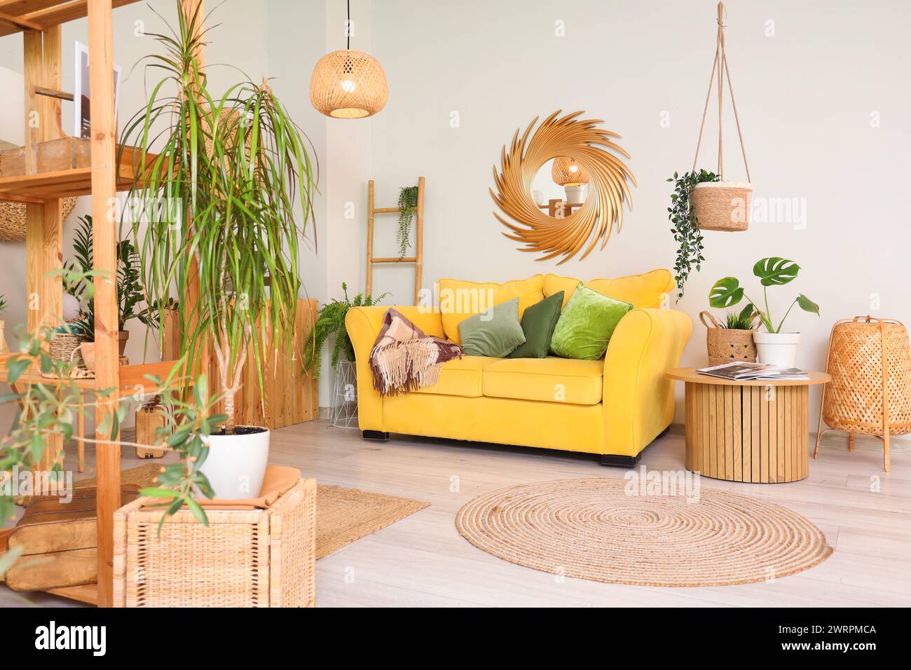 Interior of living room with green plants and sofa Stock Photo - Alamy