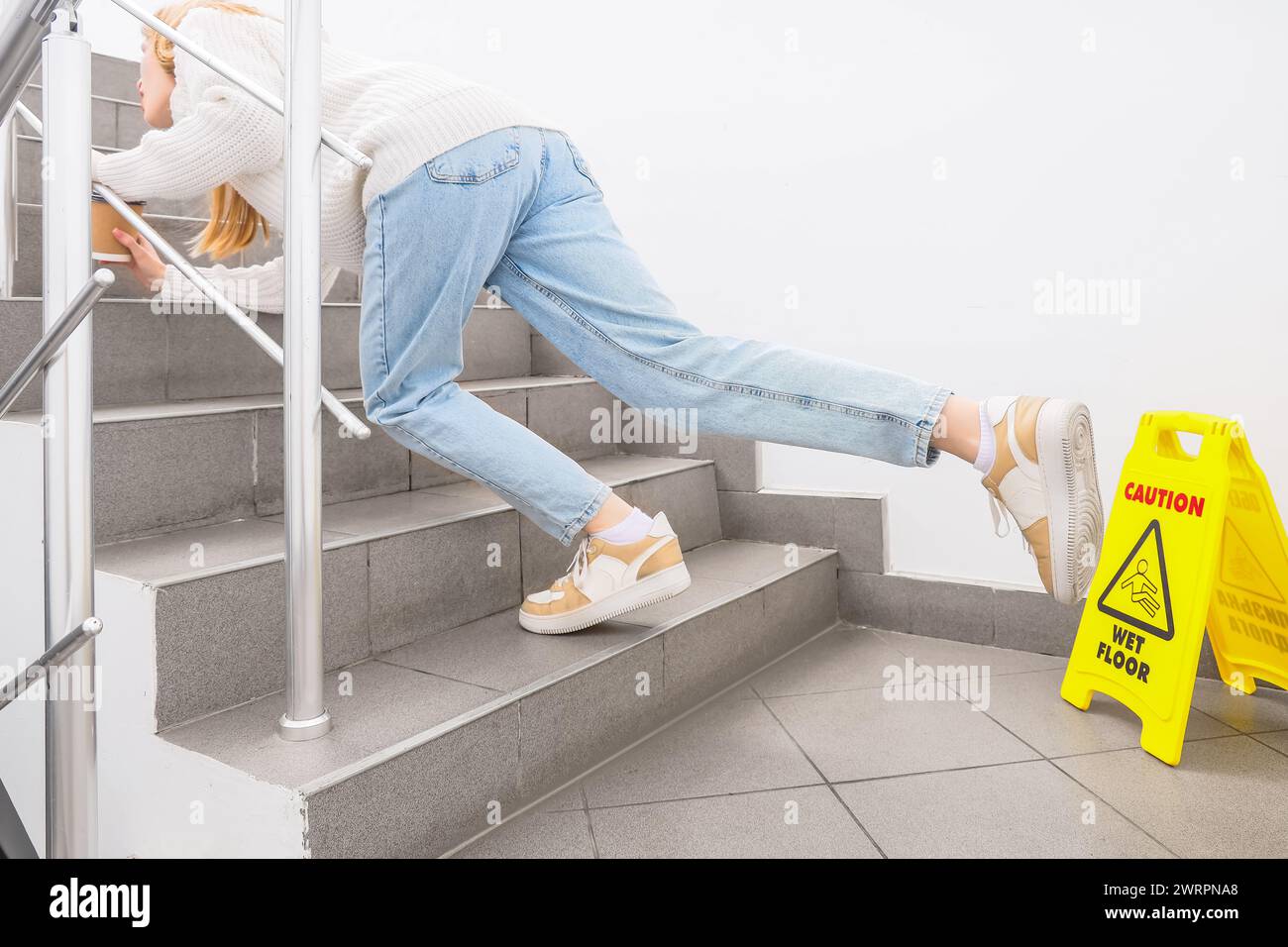 Young woman falling down on wet steps in stairway. Trauma concept Stock ...