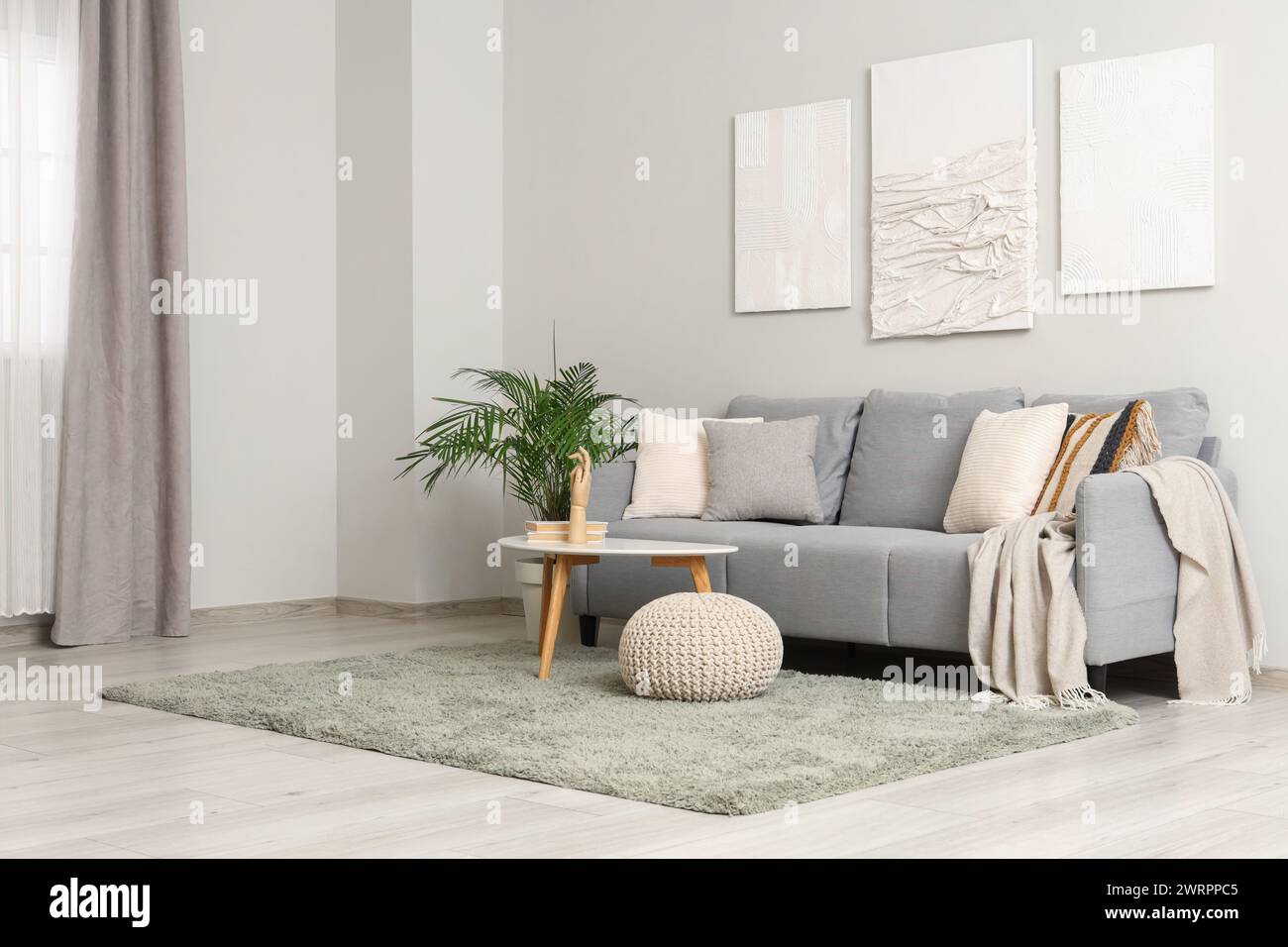 Interior of living room with sofa, pictures and coffee table Stock ...
