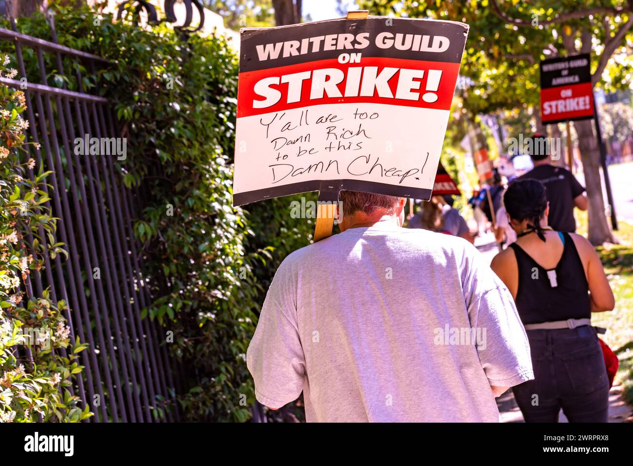 A man holds a picket sign up on July 14, 2023, Hollywood actors and writers strike, holding picket signs in front of Walt Disney Studios in Burbank, C Stock Photo