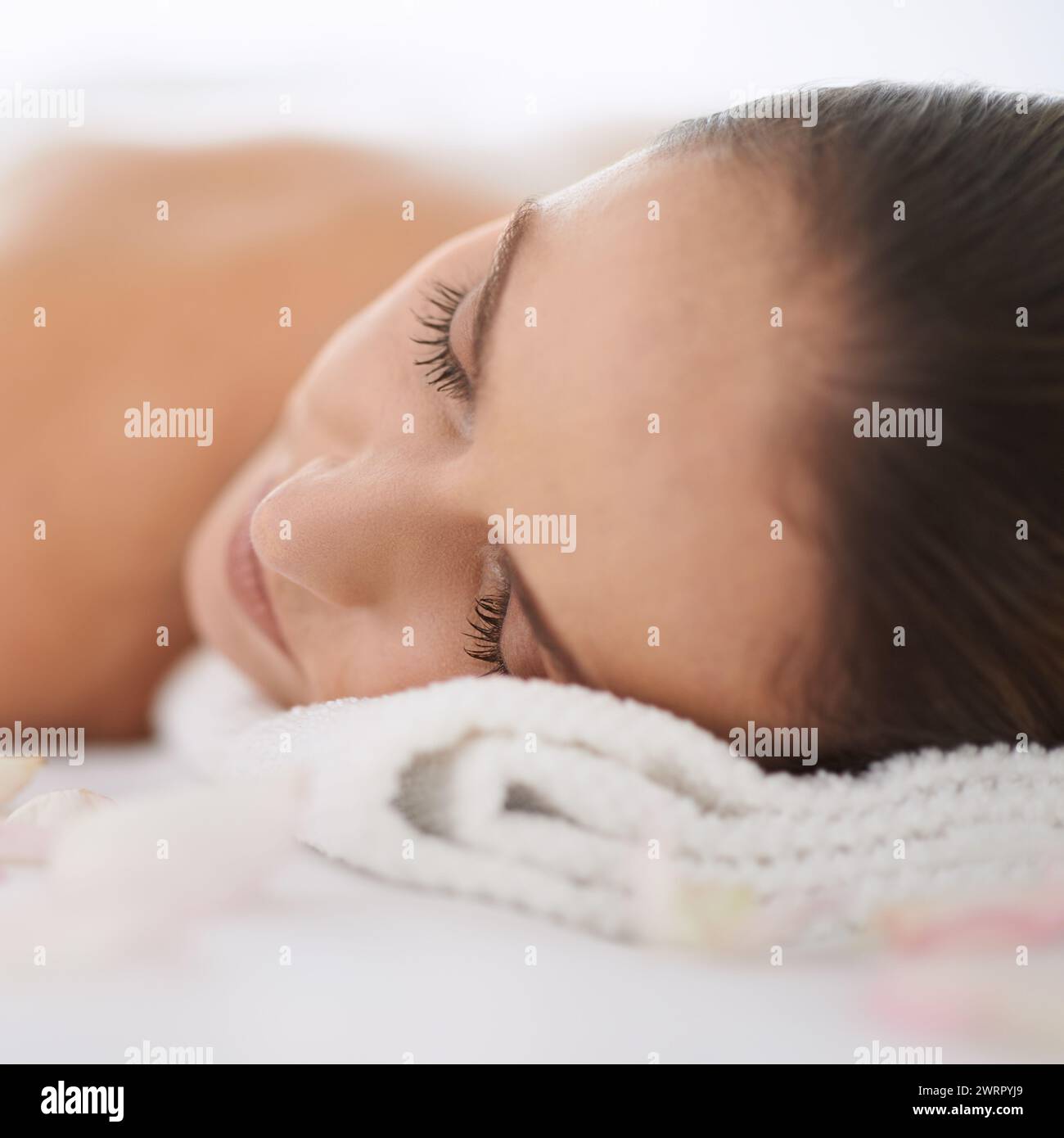 Sleep, massage and face of woman at spa for health, wellness and balance with luxury holistic treatment. Self care, peace and girl for body therapy Stock Photo