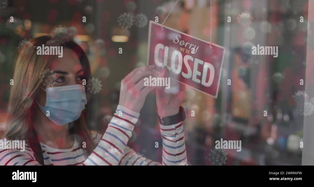 Image of coronavirus cells over caucasian female hairdresser closing