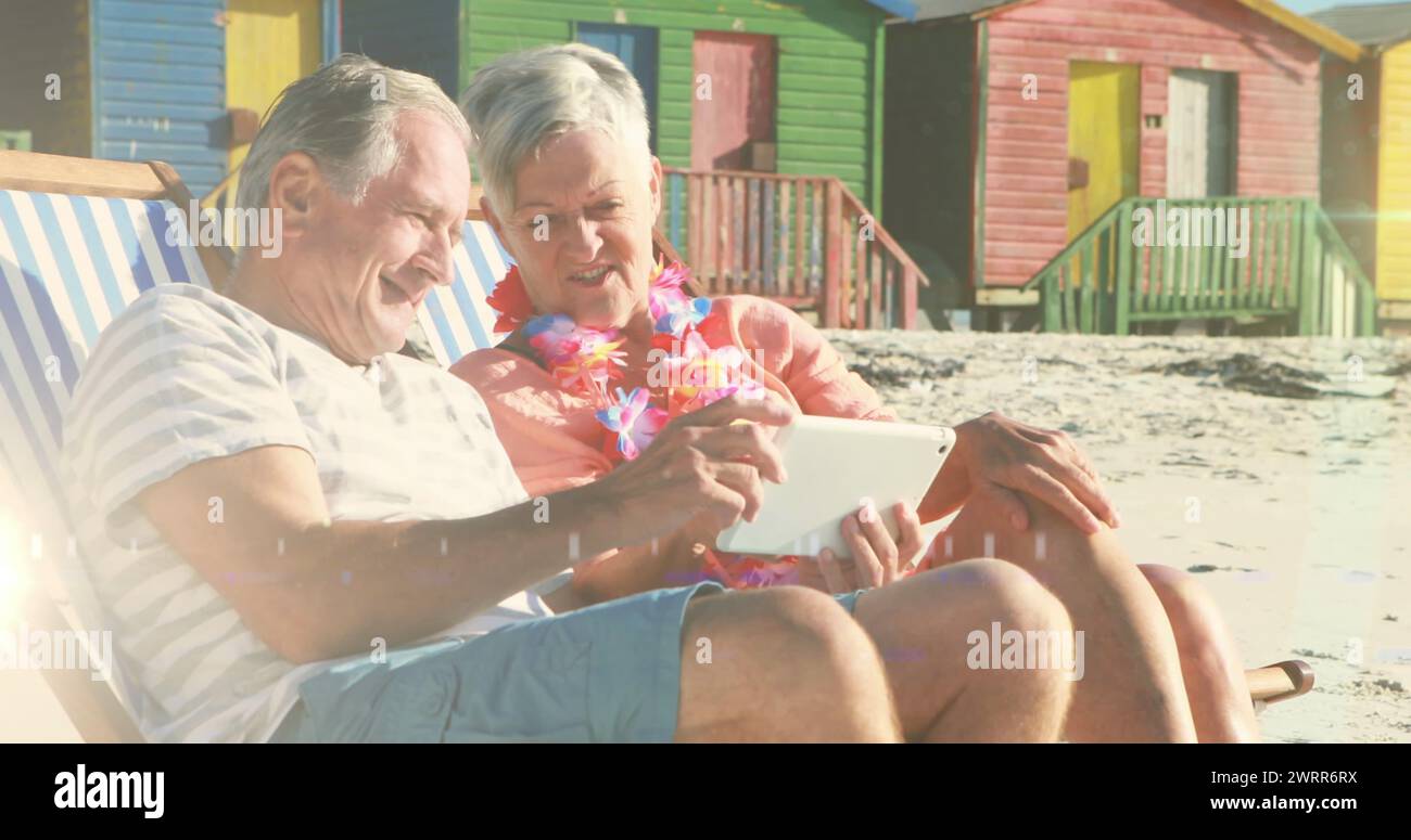Couple sitting in deckchairs on the beach hi-res stock photography and ...