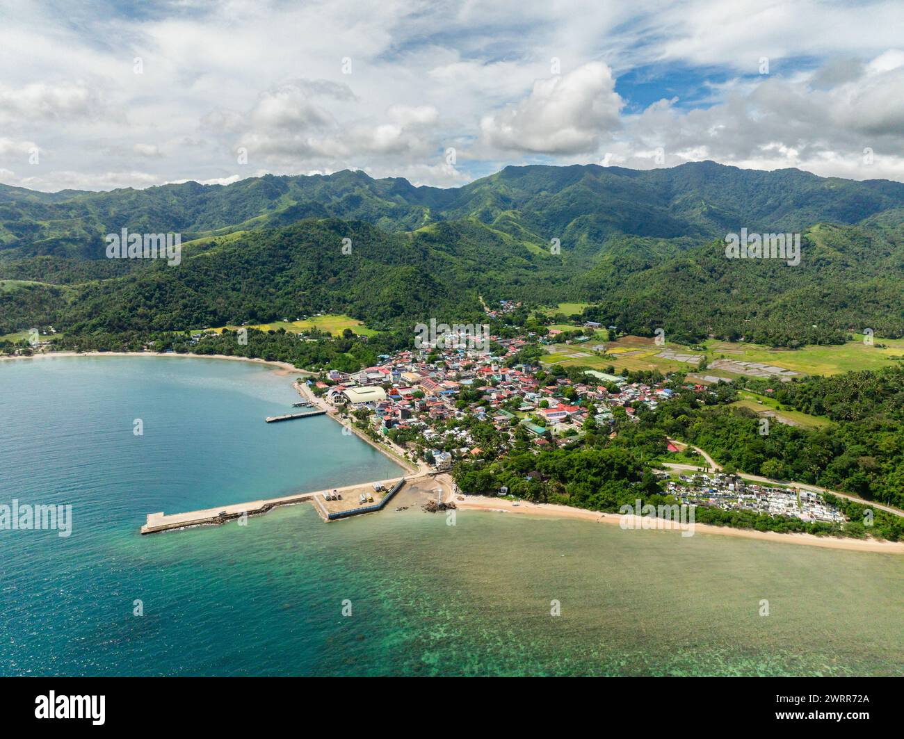 San Agustin, town city with port. Island with green mountain hills. Tablas Island. Romblon, Philippines. Stock Photo