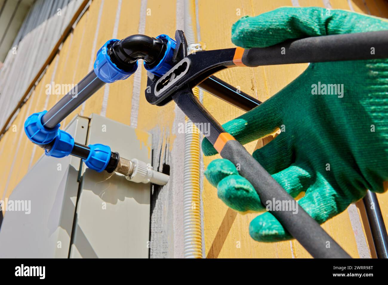 Using water pipe pliers to tighten clamp nut of compression elbow