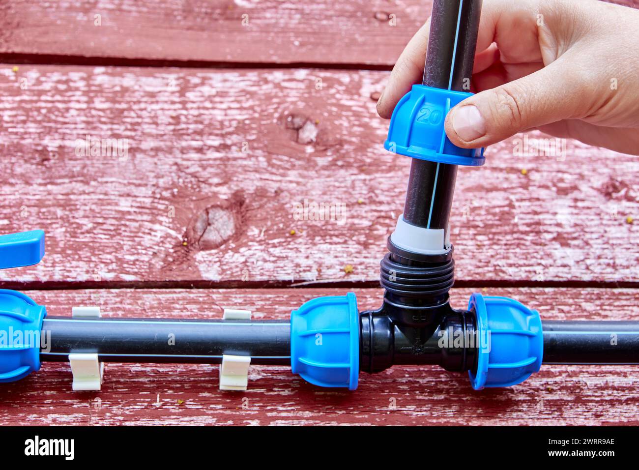 Installation of irrigation water supply with PVC pipe tee way compression clamp fitting Stock