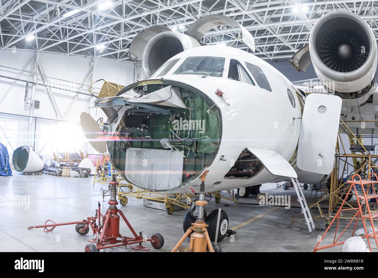 Close-up of white transport airplane in the aviation hangar. Aircraft ...