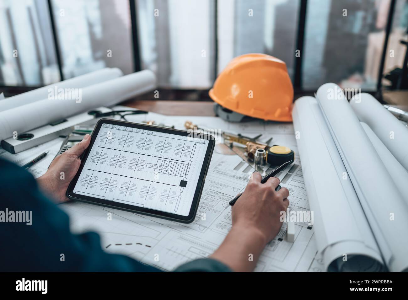 Engineering working with drawings inspection on tablet in the office ...