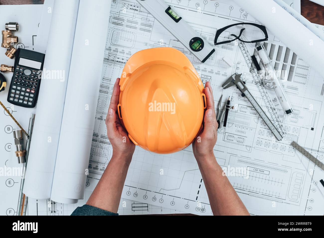 Helmet Inspeection Engineering holding safety helmet with drawings inspection on the ...
