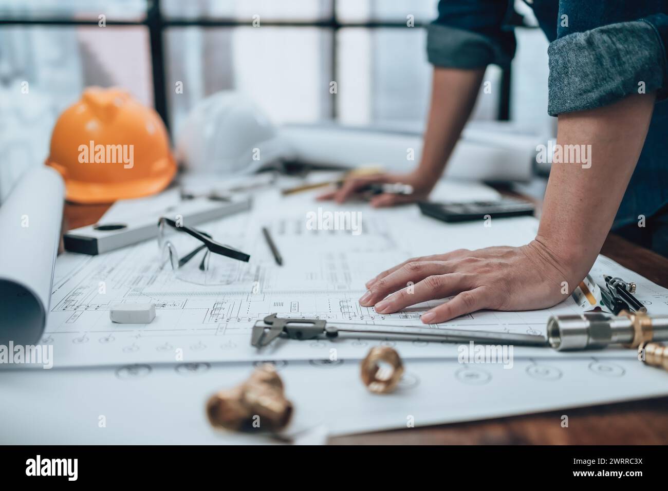 Engineering working with drawings inspection on the office desk and ...