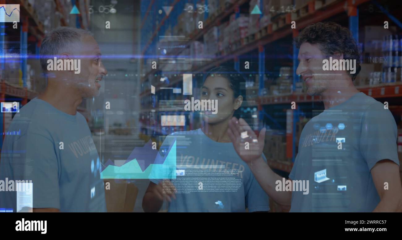 Screens with data processing against male and female volunteers high fiving each other at warehouse Stock Photo