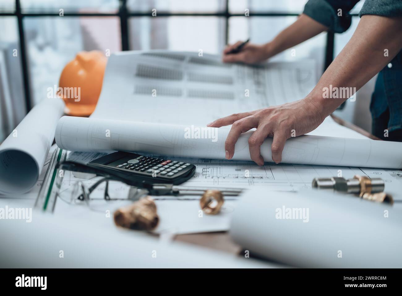 Engineering working with drawings inspection on the office desk and ...