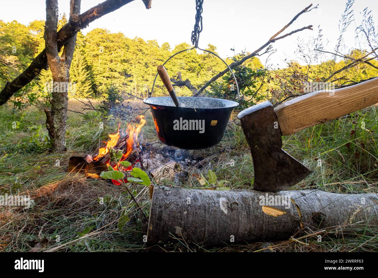 Cooking at campfire with adventure Stock Photo