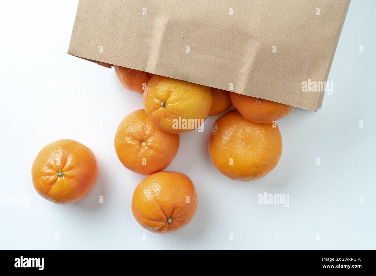A lot of oranges in a paper bag There are many benefits, high in vitamin C. Stock Photo