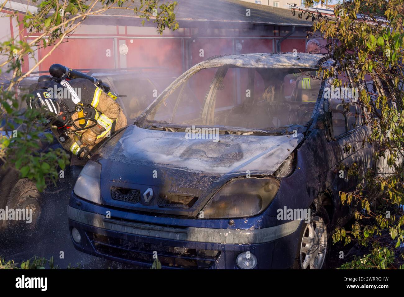 Extinguishing burning car Stock Photo