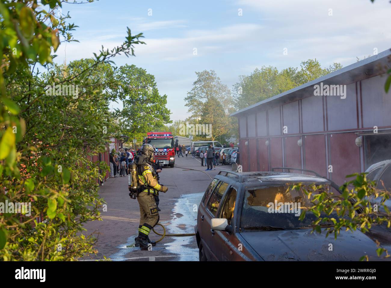 extinguishes burning car Stock Photo