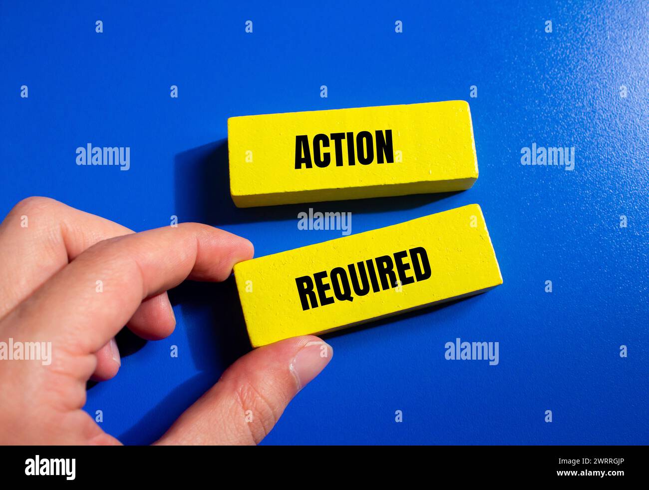 Action required words written on wooden blocks with blue background. Conceptual symbol. Copy space. Stock Photo