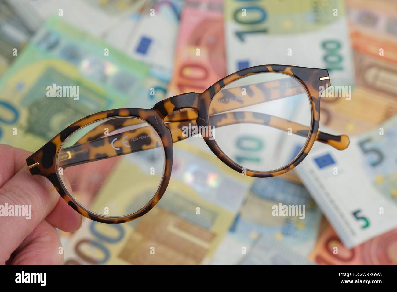 Glases over an Accumulation of euro notes Stock Photo