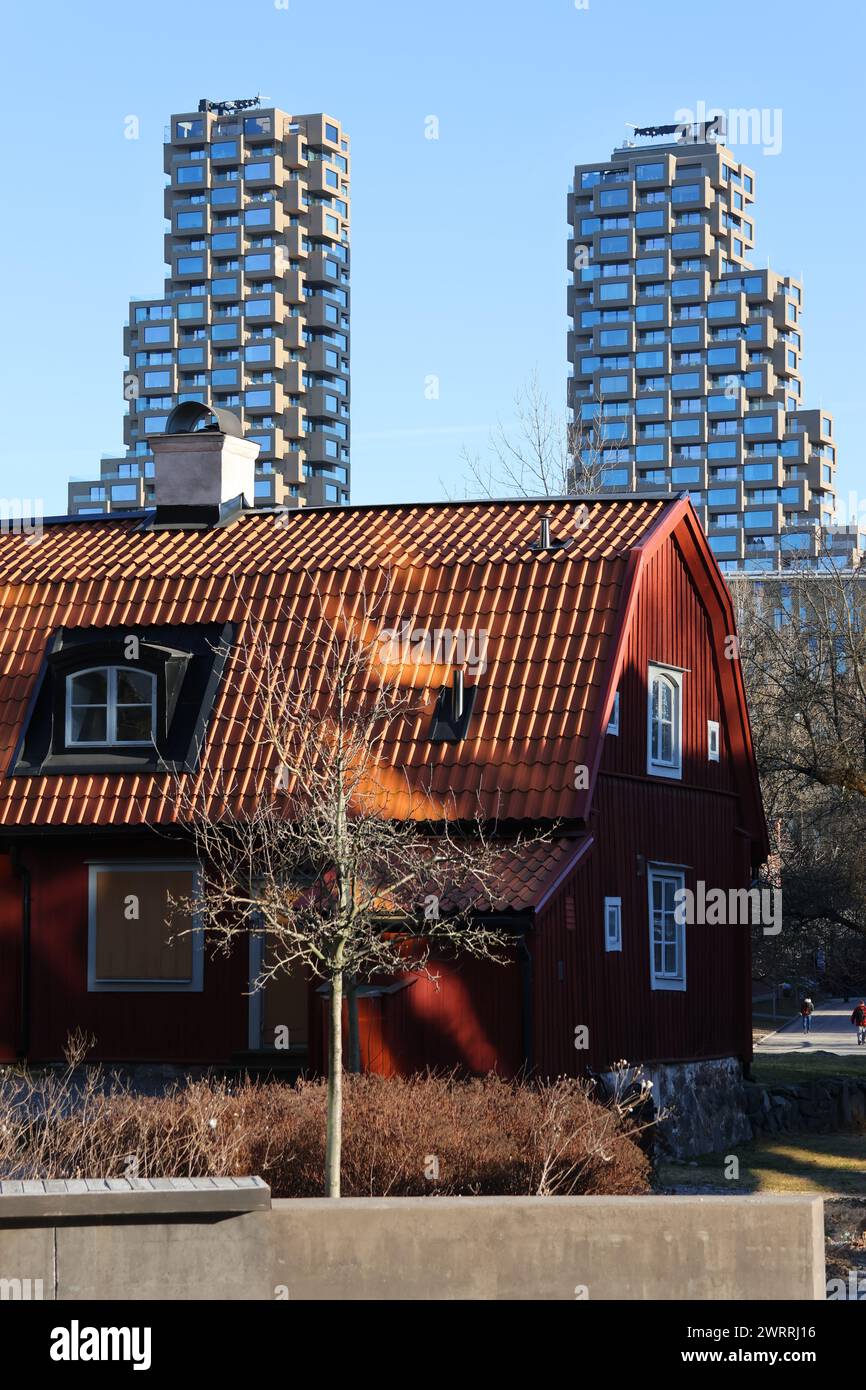 Swedish red old cottage and some of Stockholm's new modern skyscrapers Norra Tornen. In English North Towers. Stock Photo