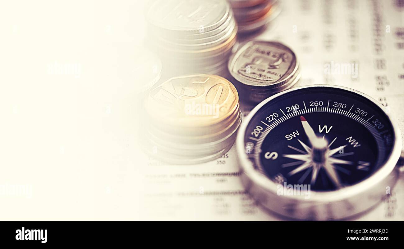 Coins, compass and business of newspaper for exchange rate, interest and direction on stock market for investor. Information, money and illustration Stock Photo