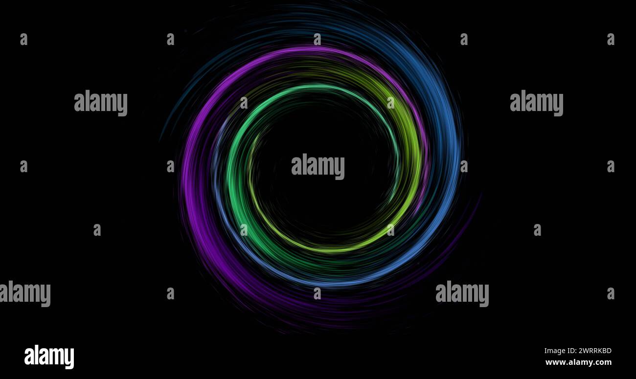 Image of colourful light trails forming circles on black background Stock Photo