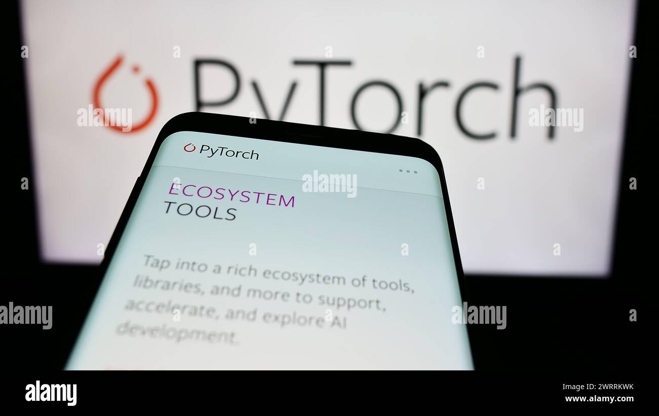 Mobile phone with website of machine learning library PyTorch in front ...