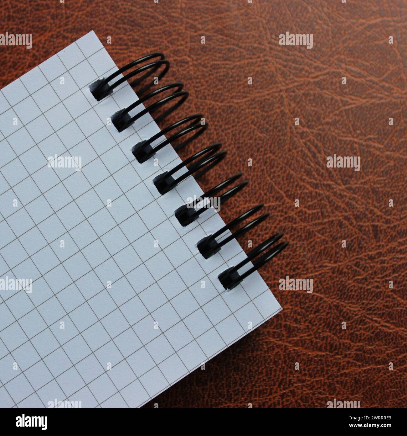 Square Image Of Bound Notepad With White Page On Leather Surface Stock Photo