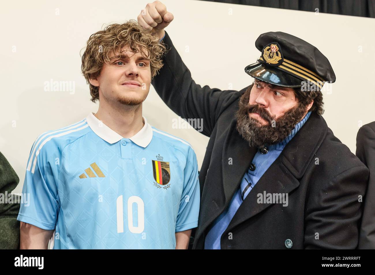 A man dressed as cartoon character Captain Haddock (R) pretends to hit one of the models showing the home and away outfits, during a press conference of Belgian national soccer team Red Devils to present the new shirts for the UEFA Euro 2024 European Championship, Thursday 14 March 2024, at the Musee Herge in Louvain-la-Neuve. The new outfit, with light blue shirt with white collar, combined with brown shorts, refers to the iconic outfit of Kuifje - Tintin, the world-famous Belgian reporter-adventurer from the Herge comic books. BELGA PHOTO BRUNO FAHY Stock Photo