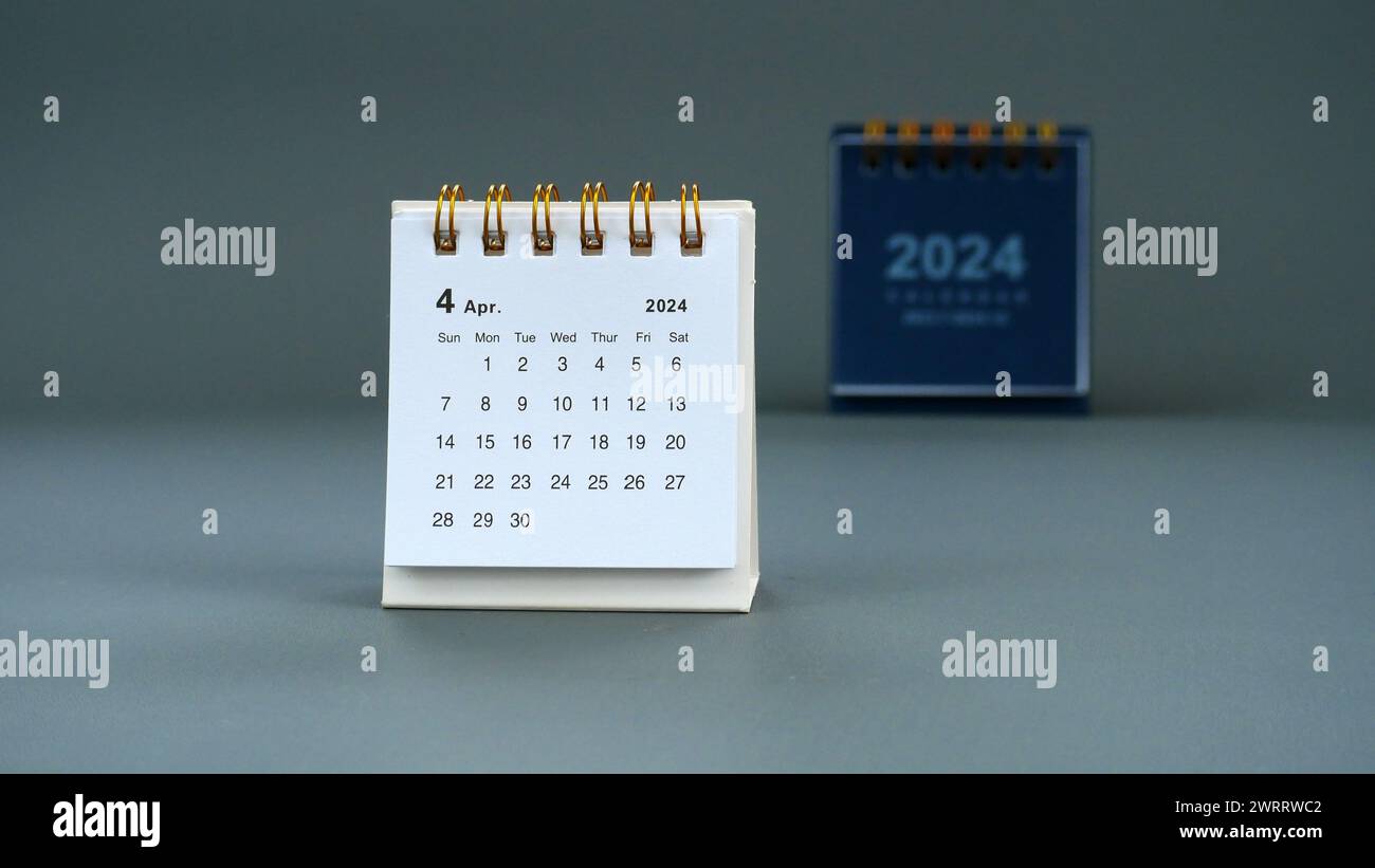 Desk calendar for April 2024 on a gray background Stock Photo
