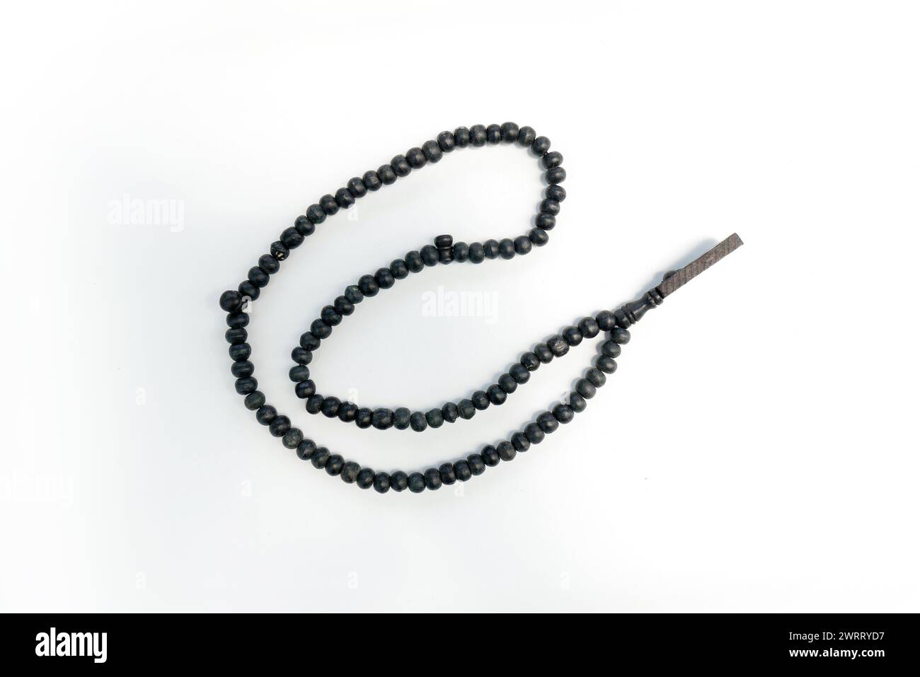 Black wooden prayer beads with 33 knots on a white background Stock Photo