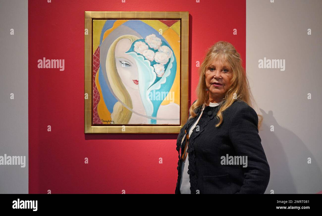 Pattie Boyd with La Jeune Fille au Bouquet, by Emile Theodore Frandsen de Schomberg, circa 1950-55, the original painting used as the cover artwork for the 1970 Derek and the Dominos album Layla and Other Assorted Love Songs, oil on canvas, signed ‘Frandsen’ lower left recto; accompanied by Pattie Boyd's correspondence with the artist's estate, estimate GBP 40,000 - GBP 60,000, during a press call at Christie's in London, to publicise the forthcoming 'The Pattie Boyd Collection sale' at the auction house. Picture date: Thursday March 14, 2024. Stock Photo