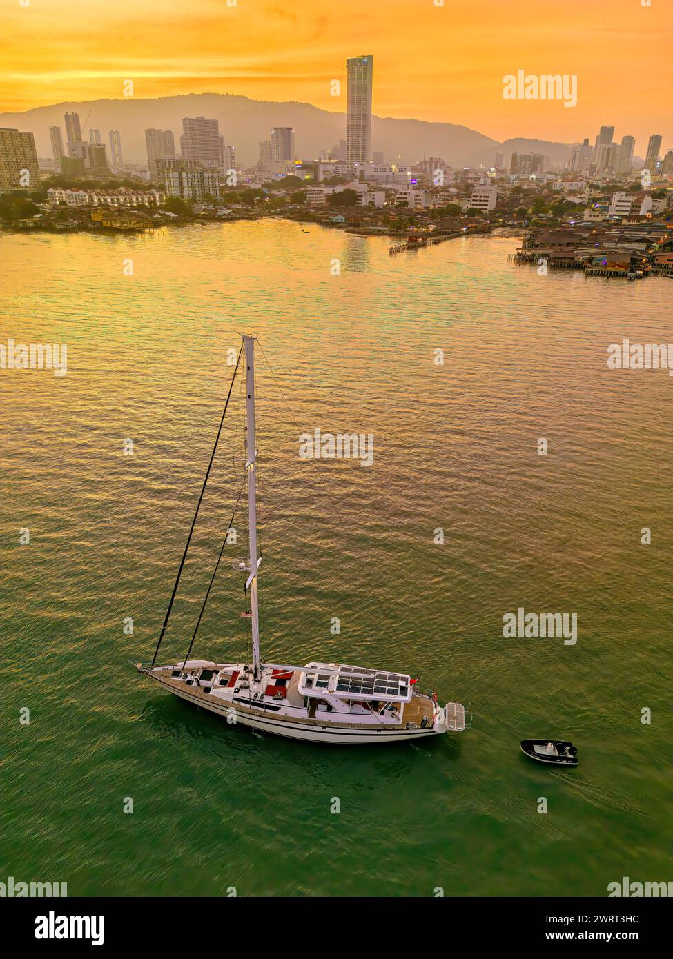 A sailboat berths at Penang Island with Komtar in the background. Stock Photo