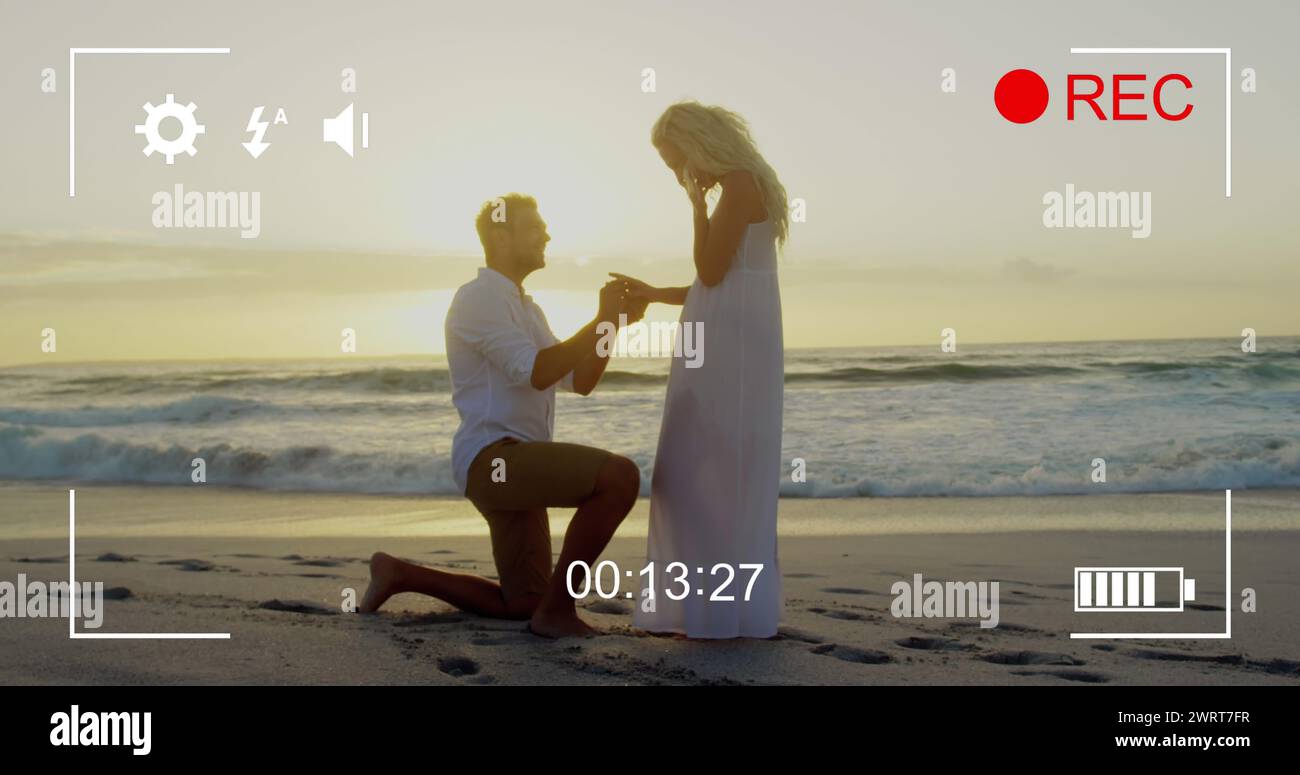 Man proposes to woman on camera in 4k with timer and icons visible. Stock Photo