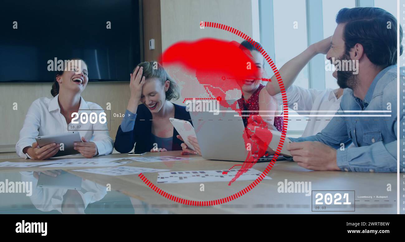 A group of business people are sitting around a conference room table ...