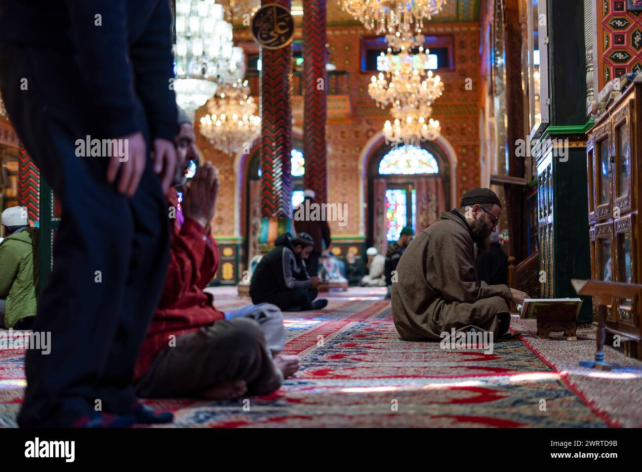 Srinagar, India. 14th Mar, 2024. A Kashmiri Muslim man reads from the ...
