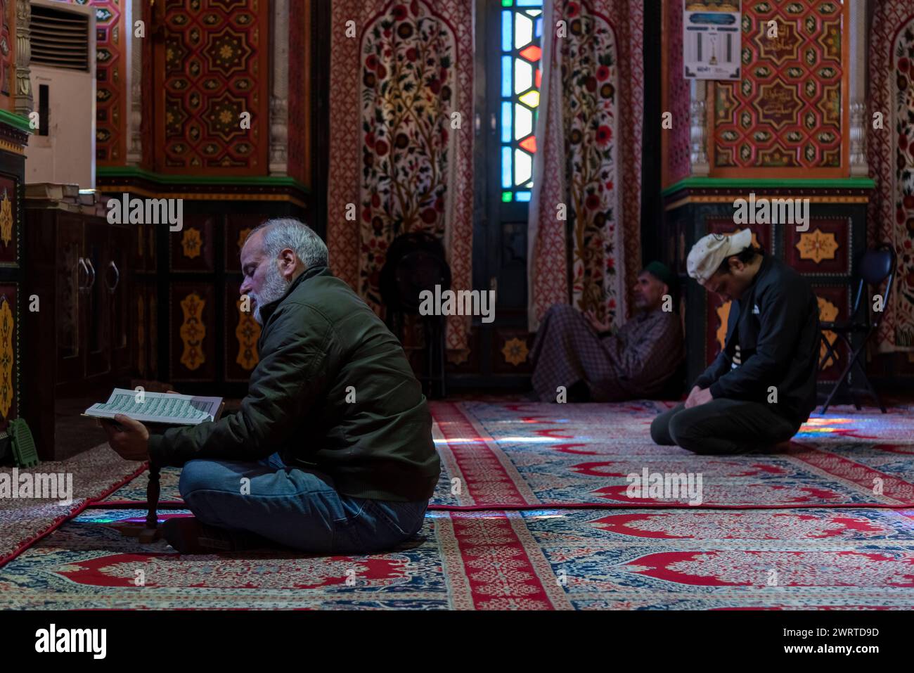 Srinagar, India. 14th Mar, 2024. A Kashmiri Muslim man reads from the ...