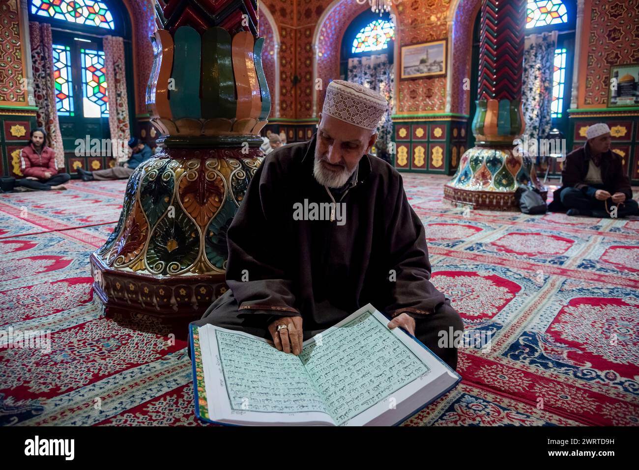 Srinagar, India. 14th Mar, 2024. A Kashmiri Muslim man reads from the ...