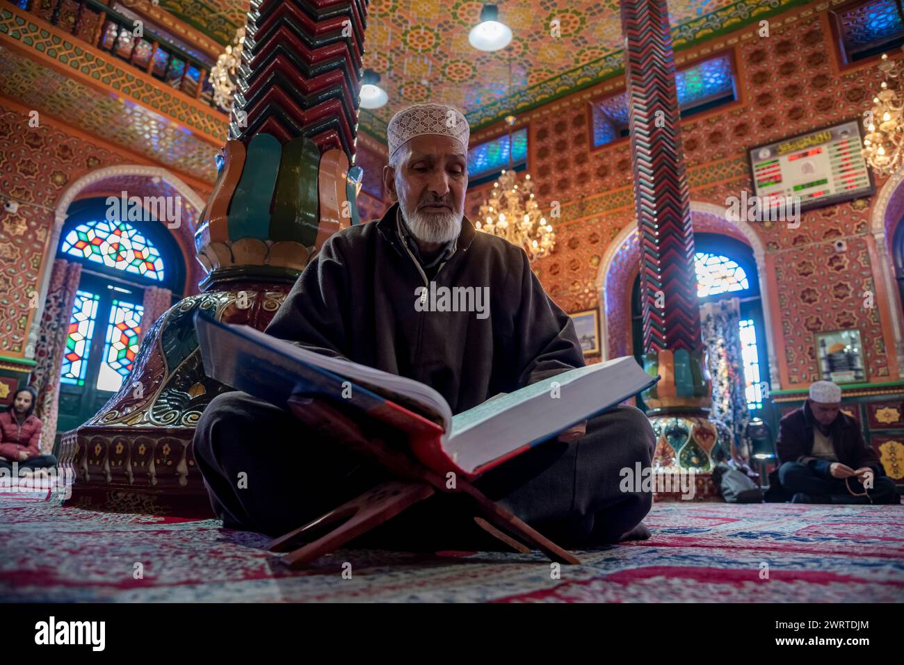 Srinagar, India. 14th Mar, 2024. A Kashmiri Muslim man reads from the ...