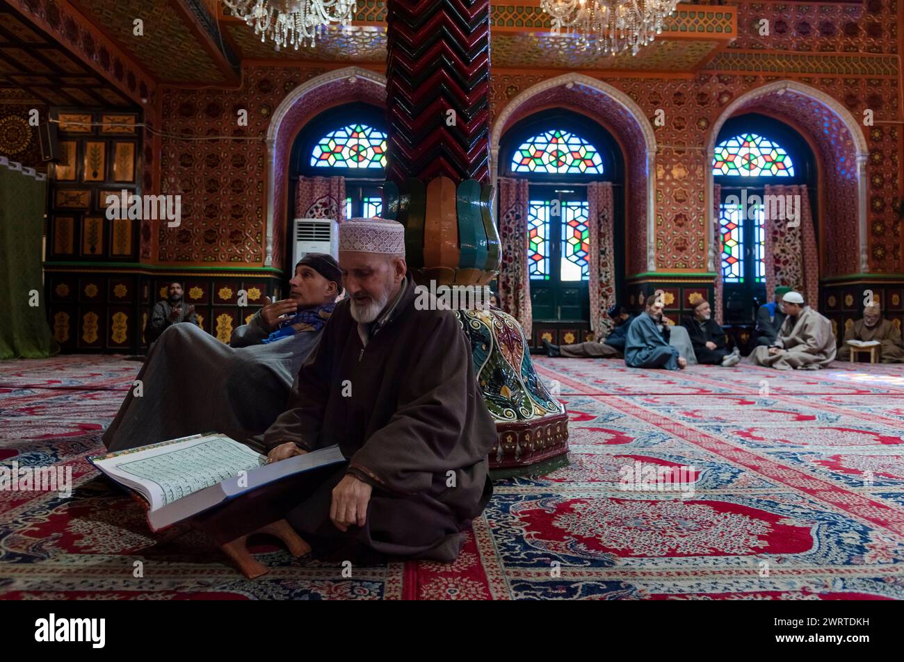 Srinagar, India. 14th Mar, 2024. A Kashmiri Muslim man reads from the ...