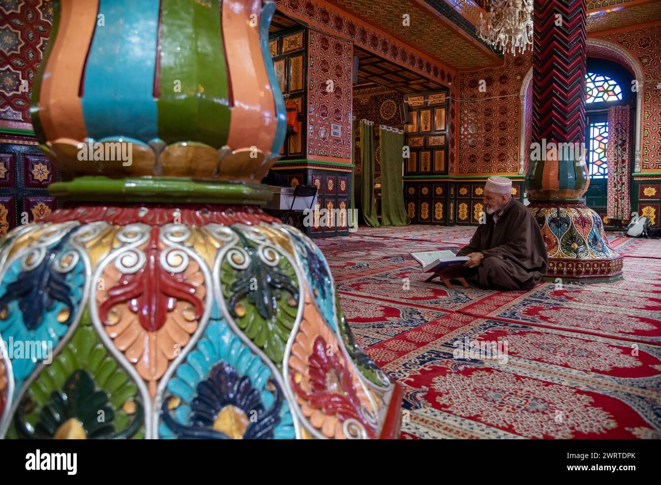 Srinagar, India. 14th Mar, 2024. A Kashmiri Muslim man reads from the ...