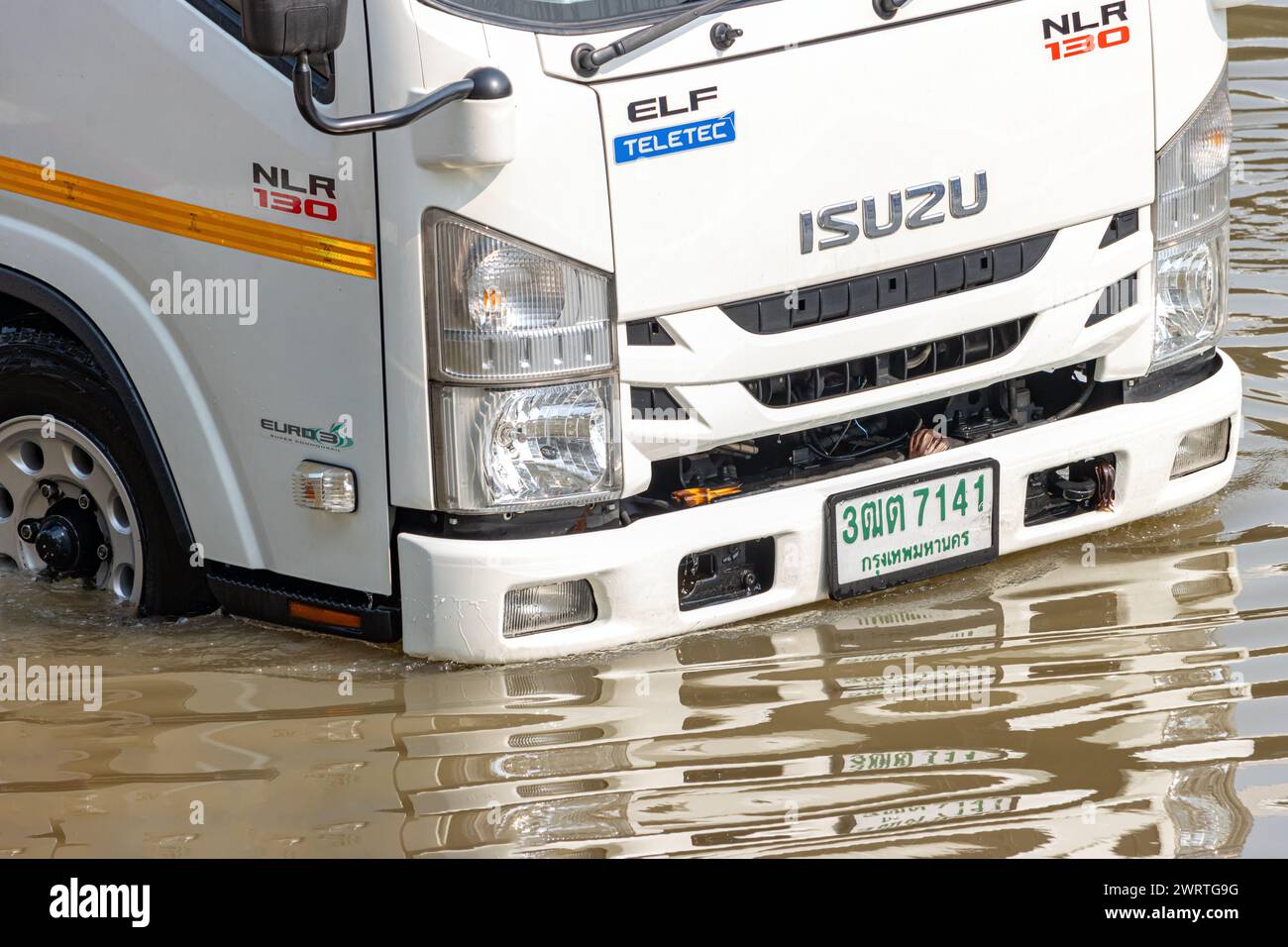 SAMUT PRAKAN, THAILAND, FEB 02 2024, A truck drives down a flooded street Stock Photo