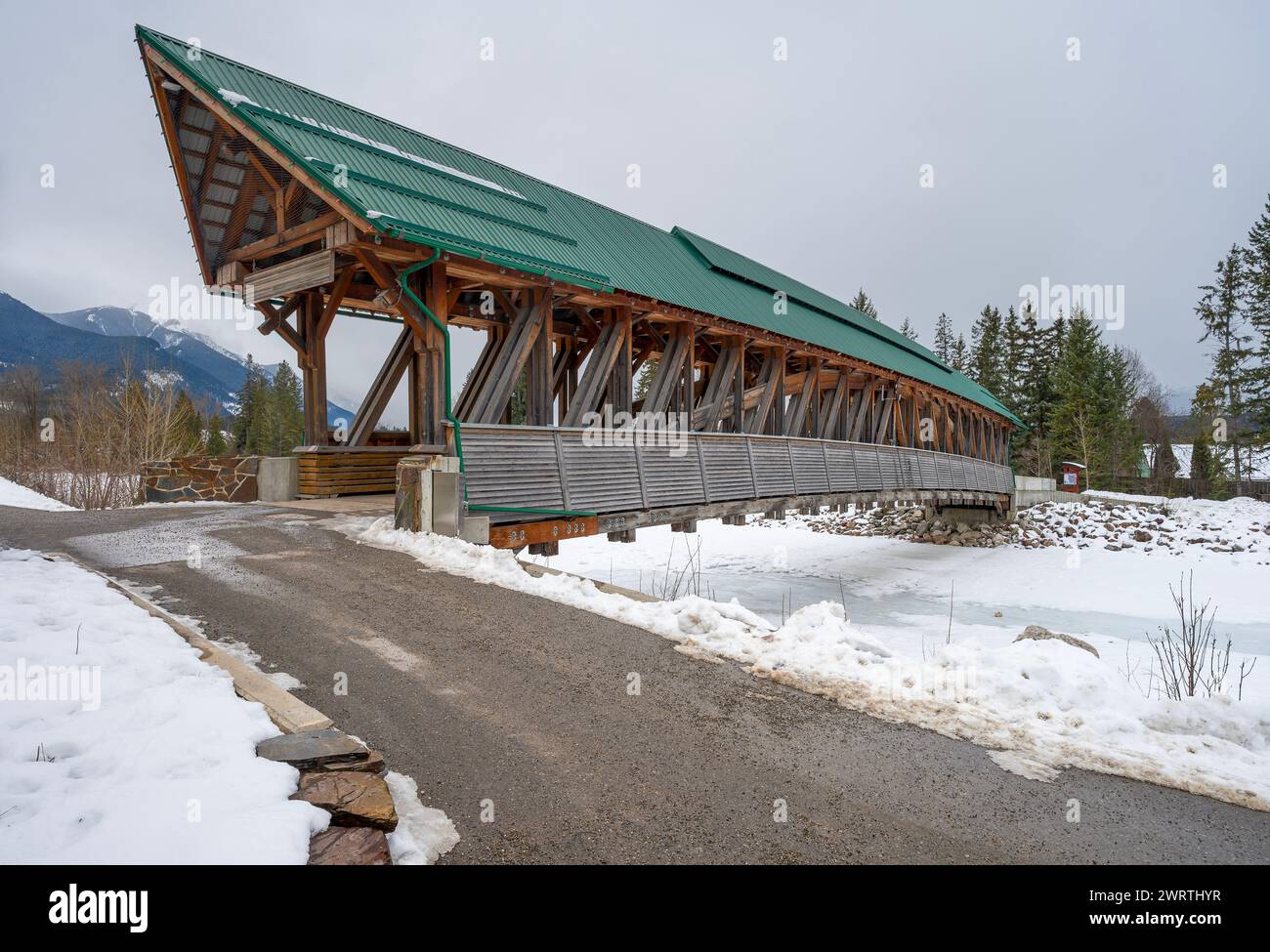 Pedestrian pathway and covered bridge over the Kicking Horse River in the town of Golden, British Columbia, Canada Stock Photo