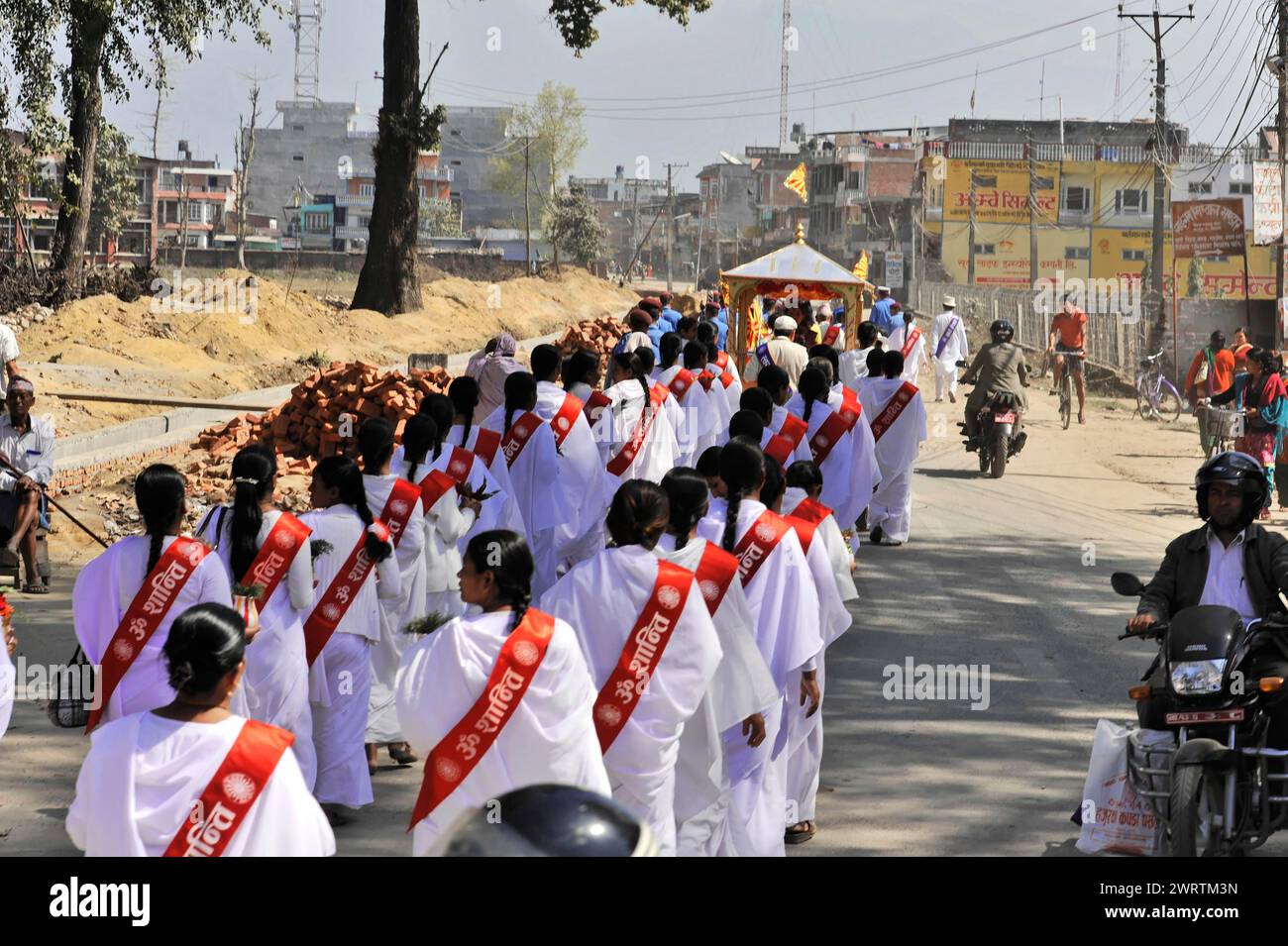 A procession of people in traditional dress with banners, Bhairahawa, Nepal Stock Photo