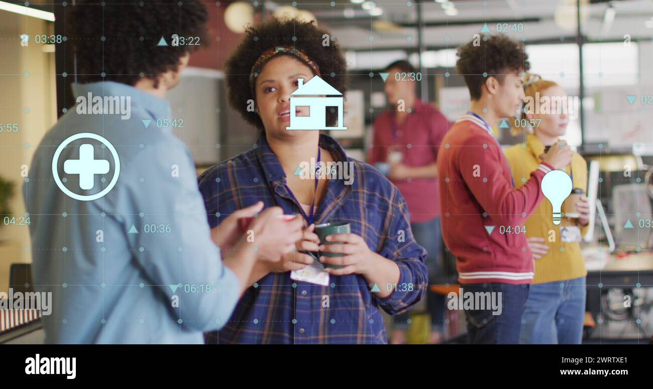 Image of changing numbers and icons over diverse coworkers discussing