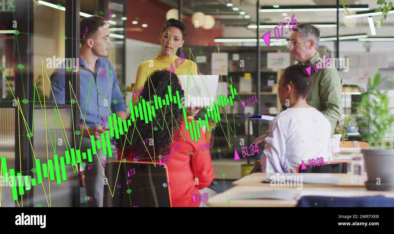 Image of multiple graphs with changing numbers over diverse coworkers sharing ideas in office Stock Photo