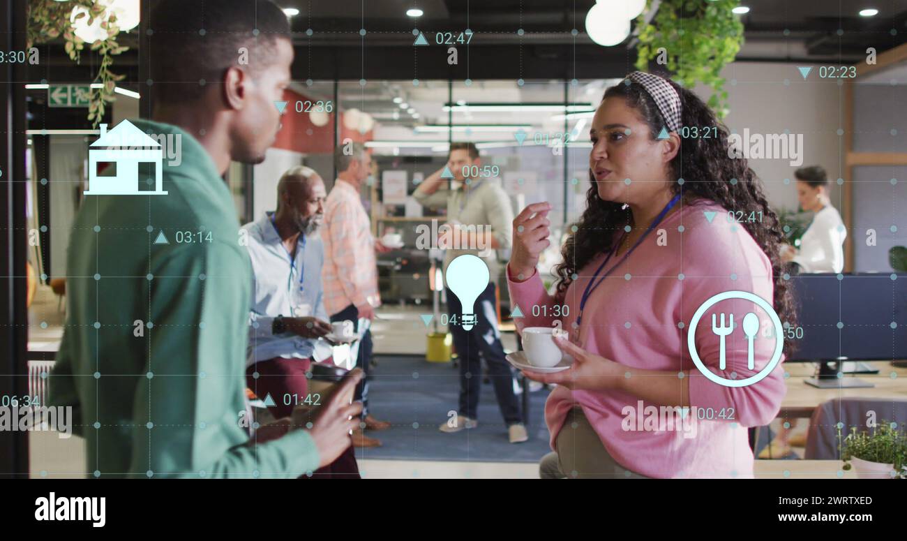 Image of changing numbers and icons over diverse coworkers discussing