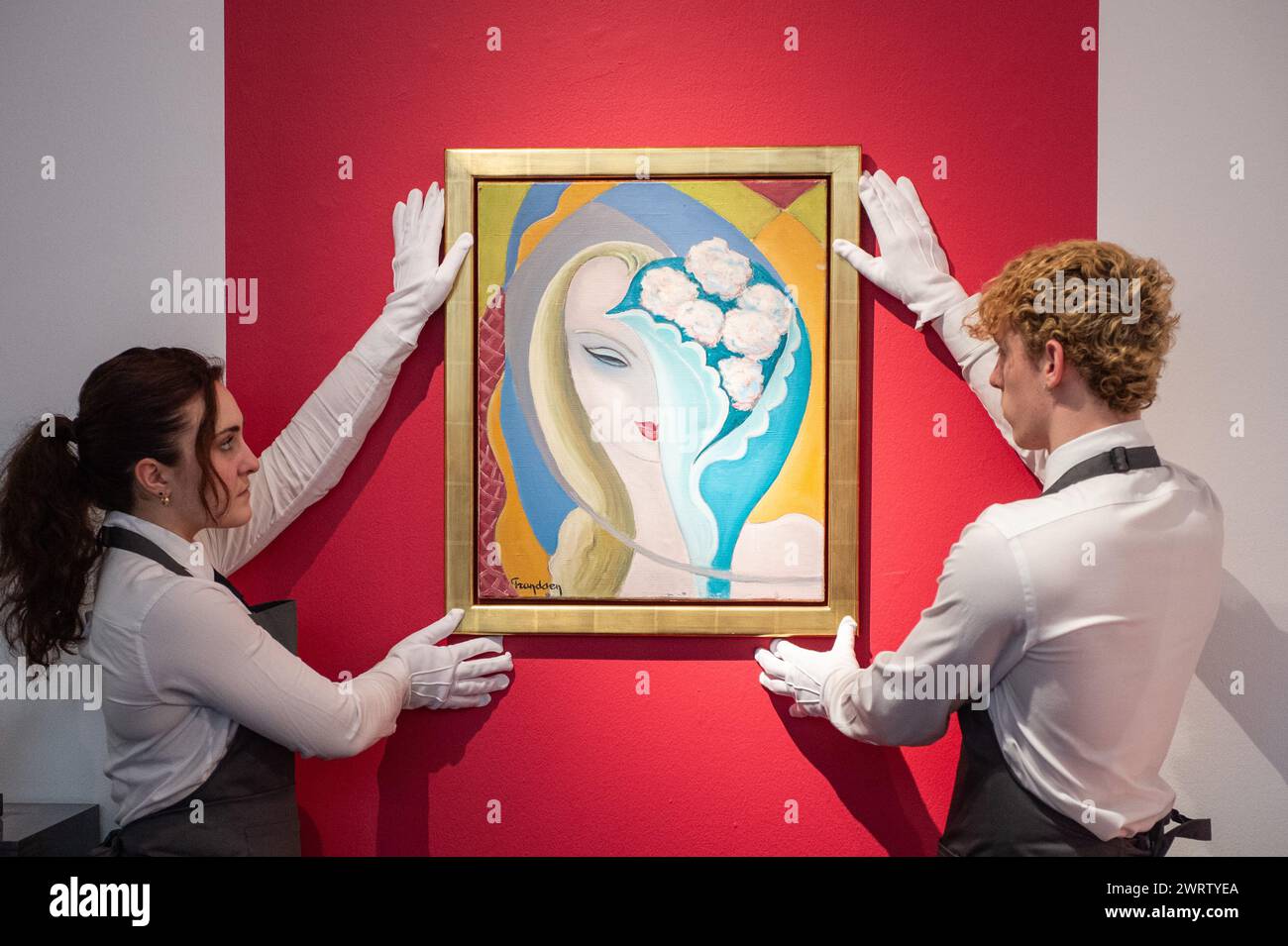 London, England, UK. 14th Mar, 2024. Christie's staff members hold the original cover art for the 1970 Derek and the Dominos album 'Layla, ' created by artist Emile Theodore Frandsen de Schomberg, estimated to be worth GBP 40,000-60,000, during a press call at Christie's in London. (Credit Image: © Thomas Krych/ZUMA Press Wire) EDITORIAL USAGE ONLY! Not for Commercial USAGE! Stock Photo