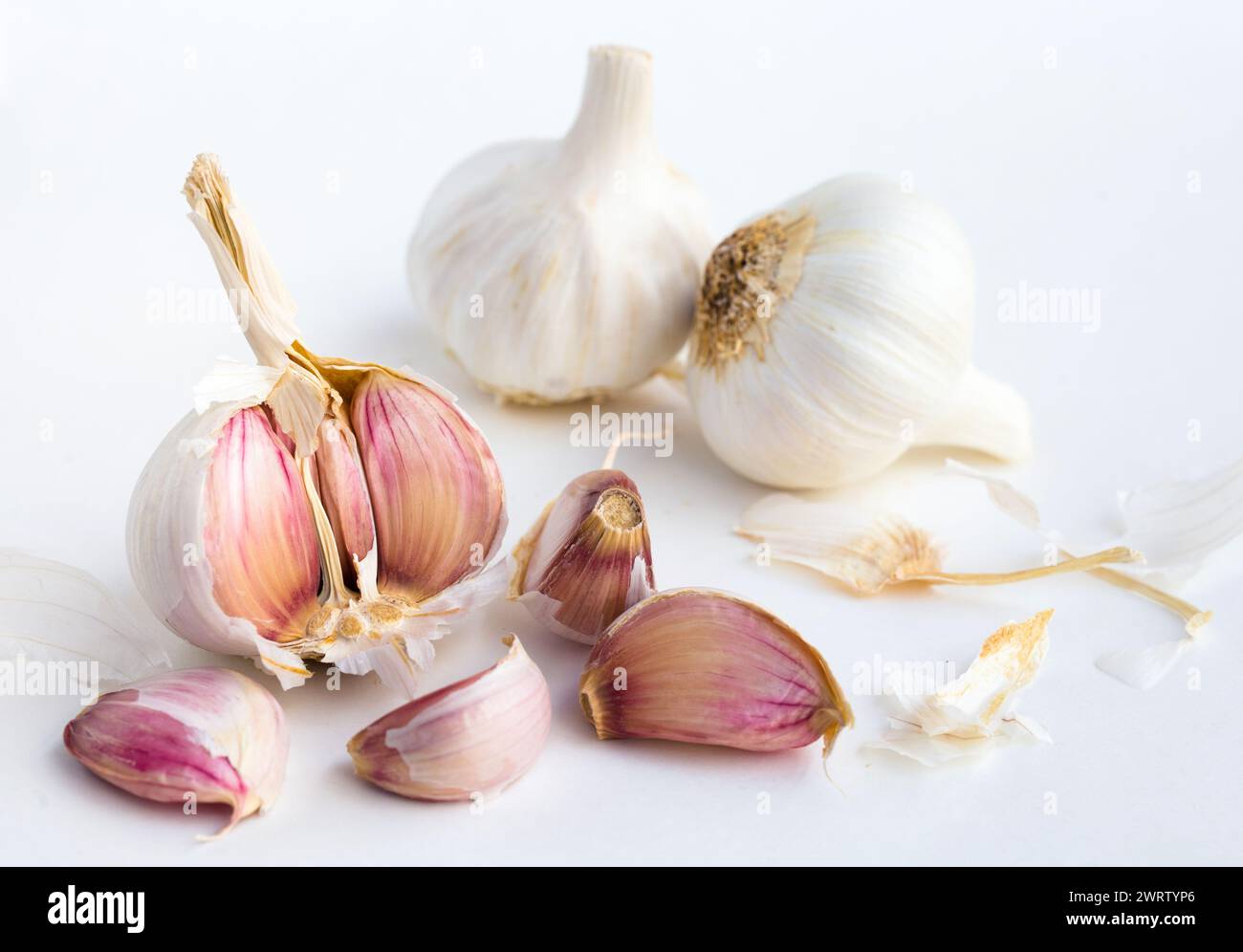 Garlic heads and cloves on white background Stock Photo - Alamy