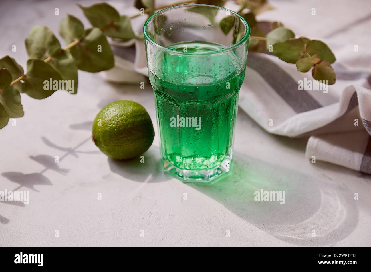 Fresh lime healthy tarragon detox sparkling, vitaminized drink. Green non alcoholic Mocktail for St. Patricks Day Stock Photo